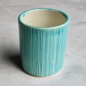 Traditionally hand made on the potters wheel and glazed with our signature Kalamalka Blue Glaze on the outside and our Heirloom Apple Orchard Ash Glaze on the inside, this porcelain tumbler is the perfect morning and evening cup. From coffee, tea, iced tea... to refreshing happy-hour evening beverages. This tumbler will surely fit perfectly in your life.